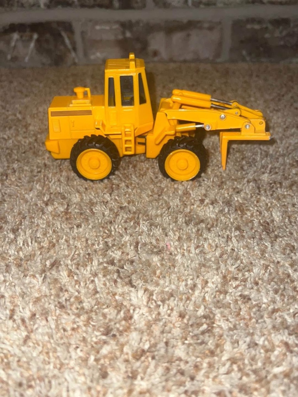 Vintage Maisto loader - has paint missing on front from play